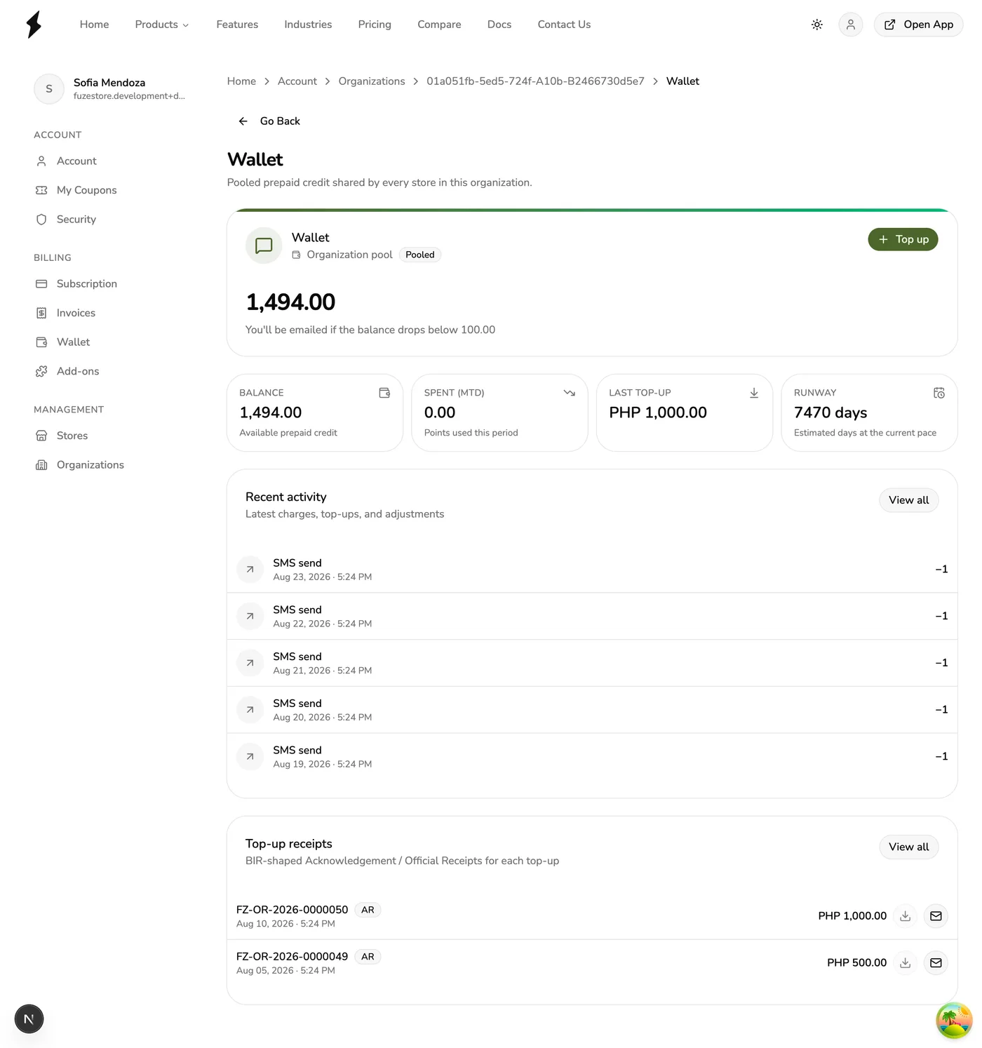 The Organization Wallet page in Fuze Store showing the pooled prepaid balance, spend-to-date, last top-up, runway, recent SMS activity, and top-up receipts